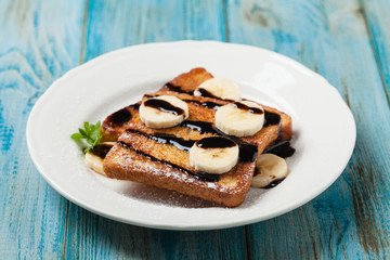 Traditional, delicious, sweet French toast with fruit and butter.