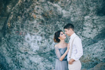 Portrait of the newlyweds near the rocks,