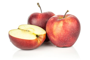 Two red delicious apples with a half isolated on white background cross section.