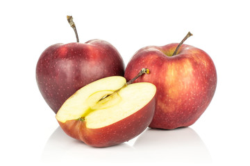 Two red delicious apples with a section half isolated on white background.