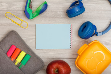 Bag-pencil case with color felt pens and marker, apple, notebook, stapler, headphones and lunch box