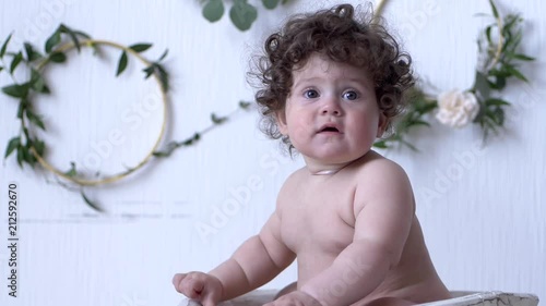Child Photo Session Small Girl With Curly Hair Sits On Background