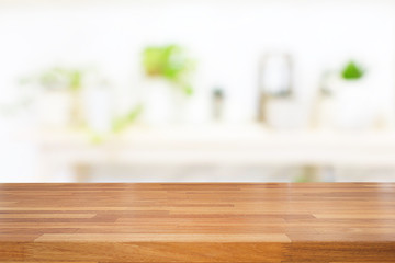 Empty wooden table and blurred interior background with small trees in coffee cafe, product display, Ready for product montage.white tone