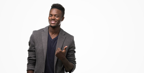 Young african american man wearing a jacket happy with big smile doing ok sign, thumb up with...
