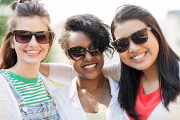 female friendship, summer and eyewear - happy young women in sunglasses outdoors
