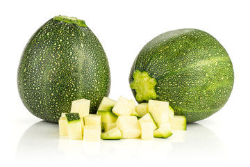 Two whole round zucchini and chopped pieces isolated on white background fresh summer squash.