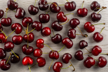Sweet bright red cherry flatlay on grey wood...........................................................................