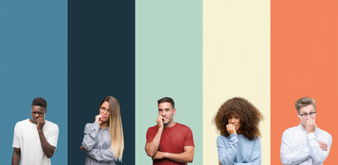 Group of people over vintage colors background looking stressed and nervous with hands on mouth...