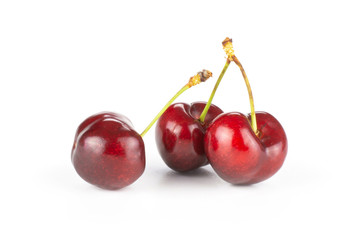 Group of three whole sweet bright red cherry isolated on white...........................................................................