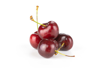 Group of four whole sweet bright red cherry heap isolated on white...........................................................................