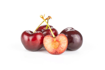 Group of three whole one half of sweet bright red cherry isolated on white...........................................................................