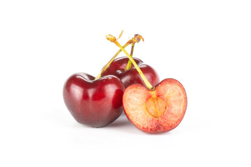 Group of two whole one half of sweet bright red cherry isolated on white...........................................................................