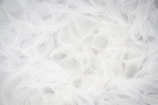 Pure white tulle fabric in an intricate frill that can be used as the background for bridal showers or baby invitations.