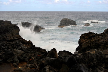 Reunion island seascape, landscape. Black sand, volcanic rocks.