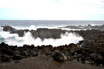 Reunion island seascape, landscape. Black sand, volcanic rocks.