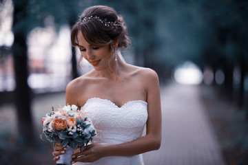 Bride autumn park in a white dress, happiness