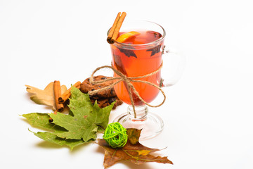 Mulled wine or hot beverage in wineglass with cinnamon sticks. Glass with mulled wine or hot drink...