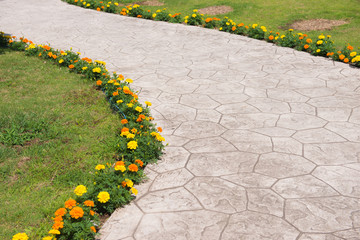 Empty pavement with colorful flowers in the park.