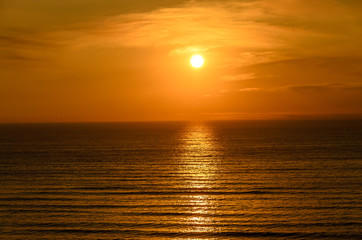 Obraz premium Beach of Black Sea from Mamaia, Romania with golden orange sky, sands and blue clear water, sunrise