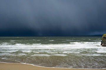 winter rain storm approaching cliff