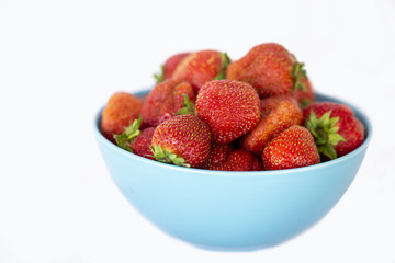 strawberry in blue bowl on white background