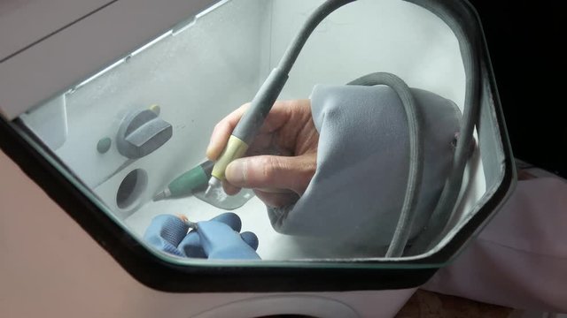 Dental technician sandblasting treatment