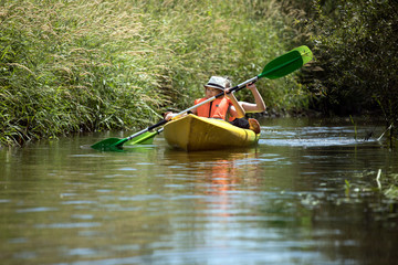 Two happy girls enjoying kayak on the river