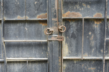iron door with old opened lock with rusty rings.