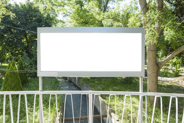Billboard over a bridge in the middle of a forest, and a evacuation rain water chanel.