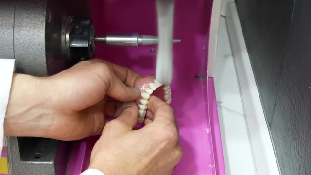 Dental Technician polishing a dental prosthesis