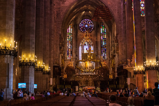 Tourists inside the Cathedral of Santa Maria of Palma, also known as La Seu