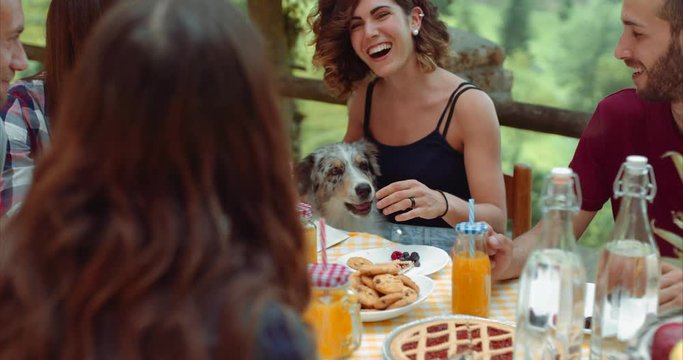 group of friends doing breakfast outdoors in a traditional countryside. shot in slow motion