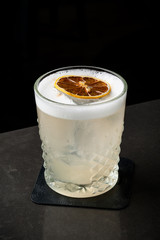 The bartender makes a cocktail of milk and ice. Macro, black background