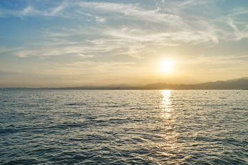 Spectacular sunset with beautiful light at City of Bardolino / Lake Garda in Italy