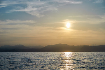 Spectacular sunset with beautiful light at City of Bardolino / Lake Garda in Italy
