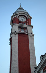 Railway station clock tower. Tower is red, decorative   details and a dome are white