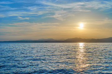 Spectacular sunset with beautiful light at City of Bardolino / Lake Garda in Italy