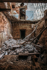 Fototapeta na wymiar Ruins of abandoned old broken industrial factory or warehouse buildings inside after disaster, war or cataclysm