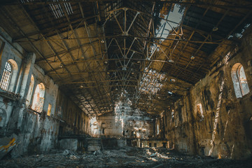 Abandoned ruins of industrial factory building inside, corridor view, perspective and sunlight,...