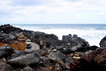 Fototapeta na wymiar Reunion island seascape, landscape. Black sand, volcanic rocks.