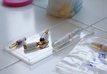 Injectable tube (amp) medicine placed in clear container.