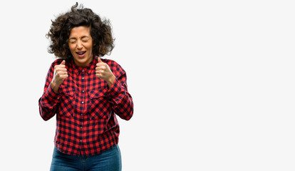 Beautiful arab woman happy and surprised cheering expressing wow gesture