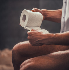Close up Young Afro-American Man Sitting on Toilet