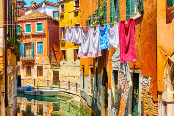 Fototapeta na wymiar Colorful old houses by canal in Venice