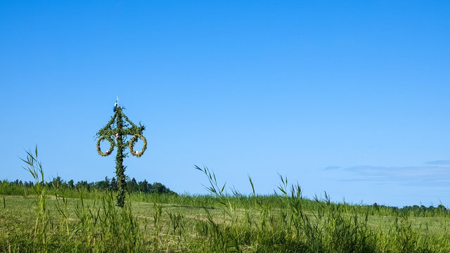 A Swedish maypole on a green summer meadow.