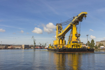 Fototapeta na wymiar Yellow ship-crane at the seaport of Gdansk. Poland