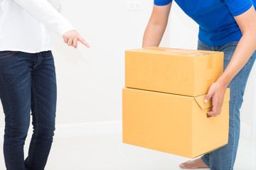 Woman receiving package from delivery man - put it down