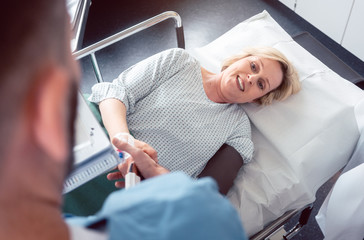 Doctor greeting patient before starting treatment in hospital
