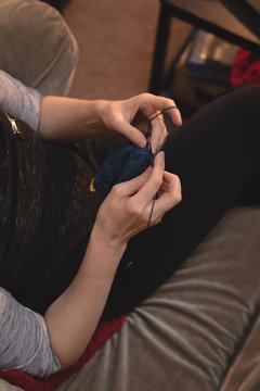 Woman knitting wool at tailor shop 