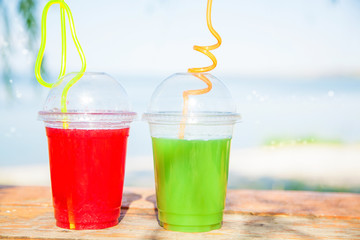 Bright Fresh healthy juices on the background of the sea. Summer, rest, healthy lifestyle Copyspace